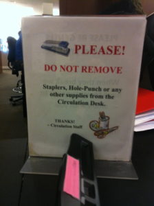 Sign in academic library next to the circulation desk.